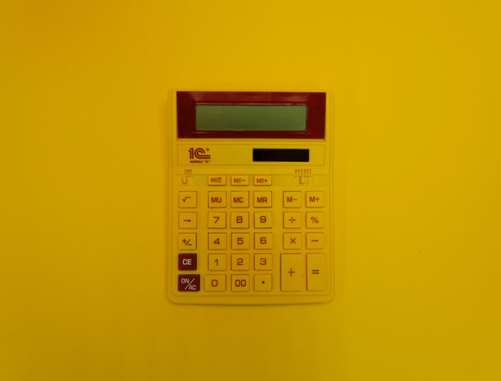 Yellow calculator on yellow background