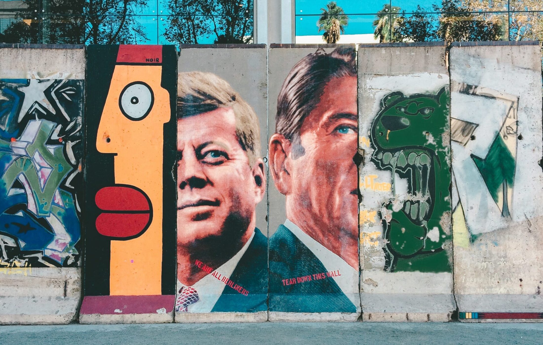 Wall with art working featuring JFK and Ronald Regan